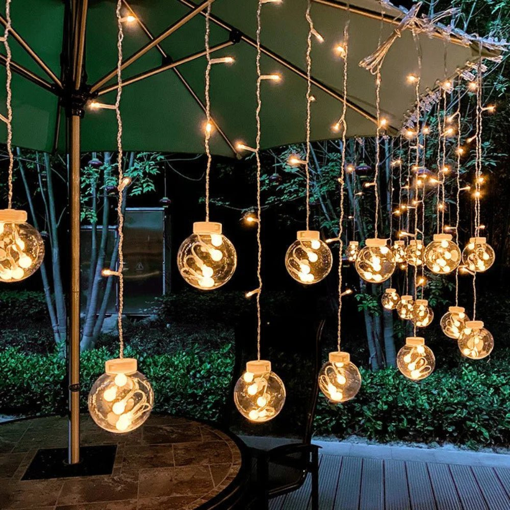 Cortina de luz com bolas suspensas — ambiente acolhedor e mágico 